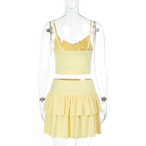 Rear view of yellow backless camisole and layered ruffle mini skirt set on a mannequin