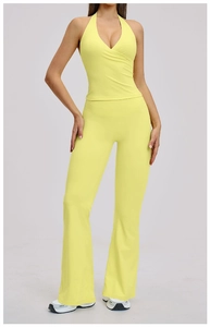 Detail of bright yellow yoga set featuring v-neck sports bra and flared leggings