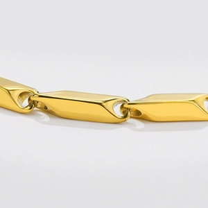 Close-up of polished gold titanium steel chain links with geometric rhombus design