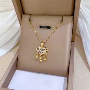 Detail of gold titanium steel ruyi lock necklace featuring full pave zircon inlay stones