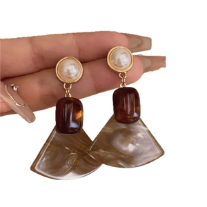 Retro resin geometric earrings with fan-shaped pendants and pearls shown in hand