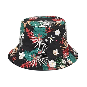 Close-up of tropical leaf print pattern on reversible sun bucket hat with white background