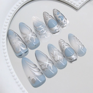 Blue gradient press-on nails with silver 3D liquid metal butterfly art in stiletto shape