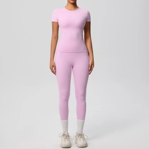 Front view of seamless high-waist lilac yoga leggings and short-sleeve gym top set