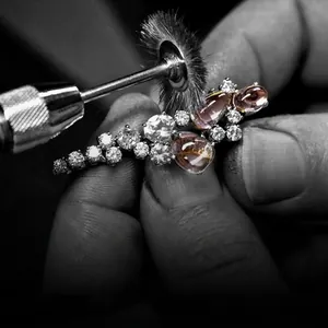 Custom jewelry process showing three pink oval gemstones being polished with metal claws