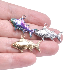 Close-up of fish-shaped stainless steel pendants in gold, silver, and rainbow plating