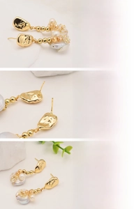 Detail view of 18K gold plated studs with natural baroque freshwater pearls