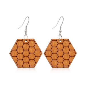 Detail of wooden hexagonal earrings with honeycomb pattern and silver metal hooks