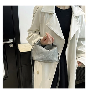 Chic grey crossbody pillow bag with vintage texture styled on a beige trench coat
