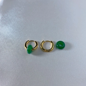 Detail of DIY 18k gold earrings with green natural stone charms and metal hoops