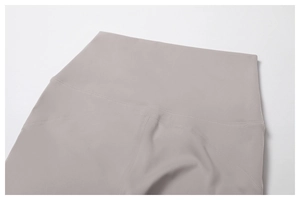 Macro detail of high-waist flared yoga pants featuring durable four-needle six-wire stitching
