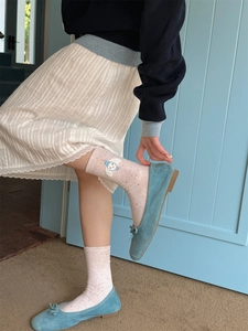 Pink crew socks with blue bear embroidery and lace trim styled with a white skirt