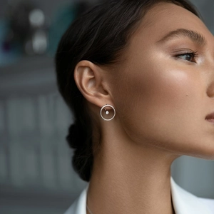 Elegant 925 sterling silver hoop earrings with center zircon worn by a model