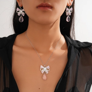 Silver bow necklace and earring set with pink zircon and teardrop crystal pendants