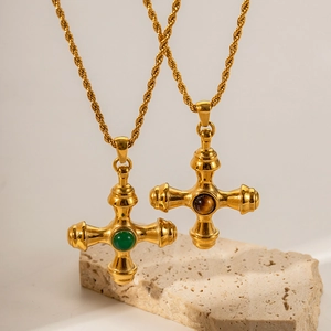 Detail of vintage gold cross necklaces with natural green and brown gemstone inlays
