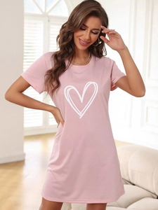 Detail of pink short sleeve pajama dress featuring a white hand-drawn heart print