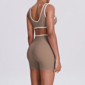 Detail of high-waist yoga shorts and racerback bra with contrast white trim