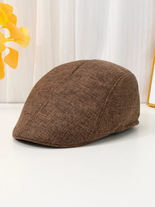 Close-up of the vintage brown linen fabric and breathable texture of the flat cap