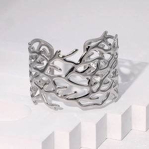 Detailed view of silver open cuff bracelet with irregular coral-inspired hollow design