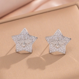 Silver star stud earrings with central bee motif and pavé cubic zirconia setting