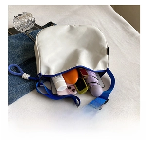 Interior view of white canvas crossbody bag showing large capacity for daily essentials