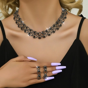 Detail of model wearing black gemstone hollow mesh necklace and earrings set