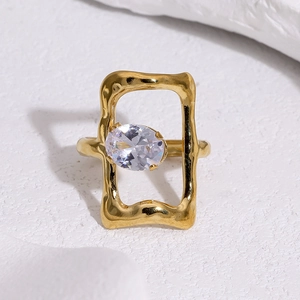Macro detail of 18k gold plated stainless steel ring with zircon and textured hollow design