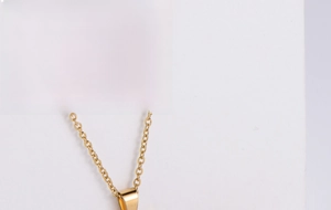 Detailed macro view of the gold-plated titanium steel butterfly pendant and earrings set