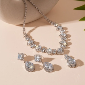Macro detail of silver necklace and teardrop earrings set with high-clarity cubic zirconia