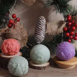 Christmas 3D embossed reindeer and snowflake ball candles on a festive wooden display