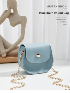 Detailed close-up of light blue PU leather texture with golden round buckle and chain strap