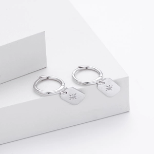 Close-up of S925 sterling silver hoop earrings with star-patterned square pendants