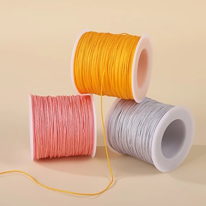 Spools of 0.8mm nylon cord in yellow, pink and silver gray for DIY jewelry making