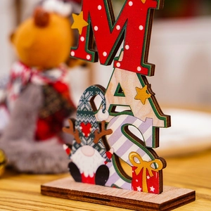 Close-up of wooden Xmas gnome table decor with colorful XMAS letters and gift box details
