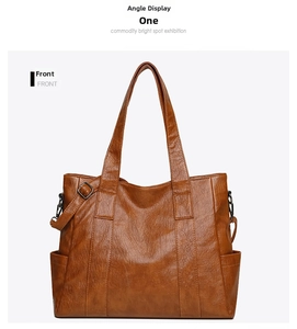 Front view of a brown vintage tote bag showing wrinkled leather texture and side pockets