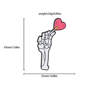 Detail showing skull hand enamel pin dimensions of 43mm height and 23mm width