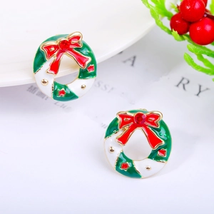 Detailed macro shot of festive Christmas wreath earrings with red bow and gold stars