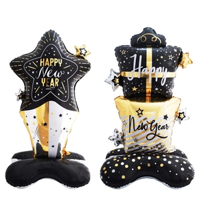 Detail of Happy New Year foil balloon stand with gold and silver star and gift box design