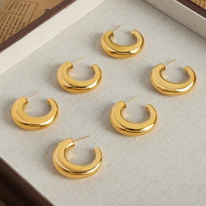Three pairs of elegant gold-plated C-shaped stud earrings in minimalist polished metal style