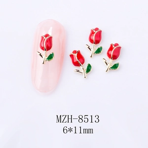 Detailed view of 6x11mm red tulip nail charms with gold trim and green leaves