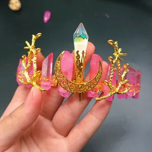 Macro detail of handmade bridal crown with pink crystals and golden metal moon accent