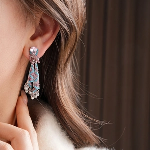 Vintage knotted oval drop earrings with diamonds and pink blue beads on female model