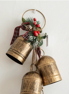 Detail showing vintage bronze metal bells with pine needles and plaid ribbon bow decoration
