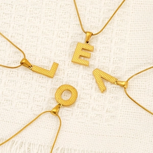 Elegant gold titanium steel letter pendant necklaces LEOV on white knit background