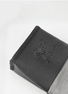 Close-up of waterproof lychee grain fabric on a portable travel makeup brush bag