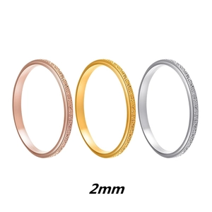 Three 2mm minimalist stainless steel rings in rose gold, gold, and silver matte finishes