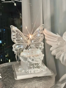 Detailed set with white lace butterfly wings, Queen crown topper, and birthday candle