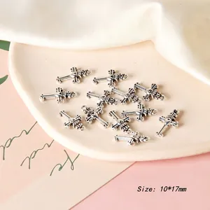 Detailed view of 10x17mm vintage silver cross charms with heart and crown motifs