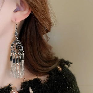 Detail of vintage silver fringe earrings with black crystal inlay on model
