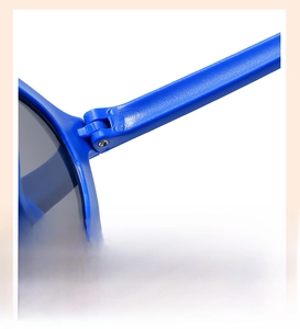 Detail of sturdy hinge on blue kids sunglasses for smooth opening and comfortable fit